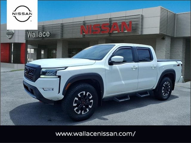 2024 Nissan Frontier PRO-4X in Glacier White Qak — front three-quarter view